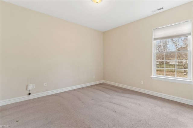 spare room featuring light carpet