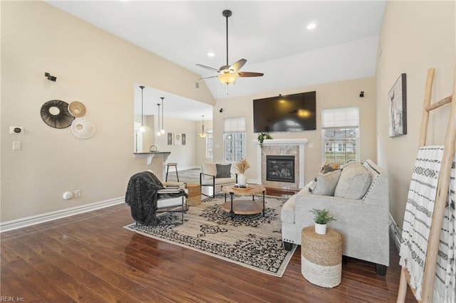 living room with vaulted ceiling, plenty of natural light, and dark wood-type flooring