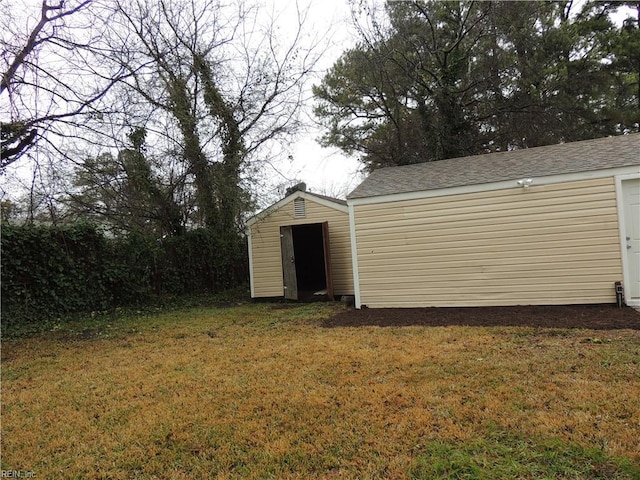 view of outbuilding with a lawn