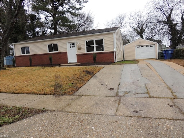 single story home with an outbuilding, a garage, and a front lawn