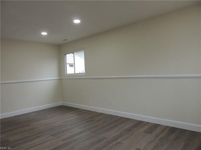 unfurnished room featuring dark wood-type flooring