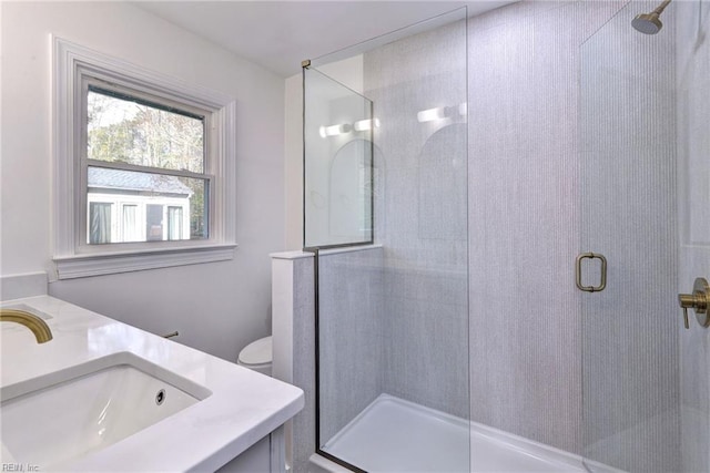 bathroom featuring vanity, toilet, and an enclosed shower