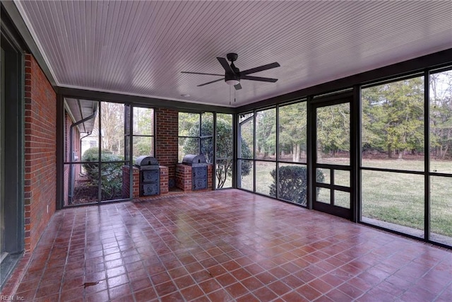 unfurnished sunroom featuring ceiling fan and wood ceiling