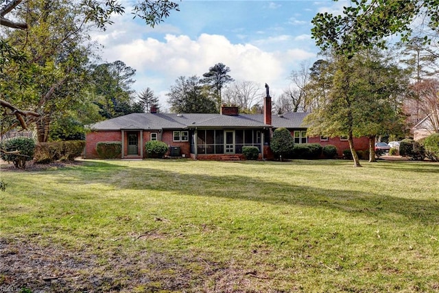 ranch-style house with a sunroom and a front yard