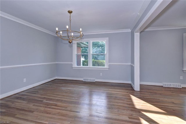 empty room with crown molding, a chandelier, and dark hardwood / wood-style flooring