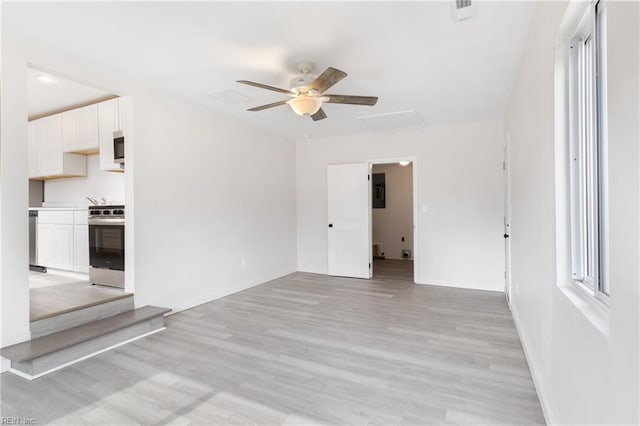 spare room featuring ceiling fan and light wood-type flooring