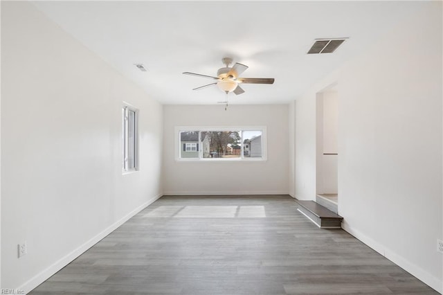 empty room featuring ceiling fan and hardwood / wood-style floors