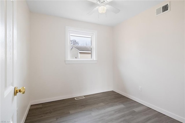 spare room with dark wood-type flooring and ceiling fan