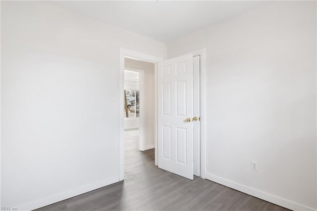 spare room with dark hardwood / wood-style floors