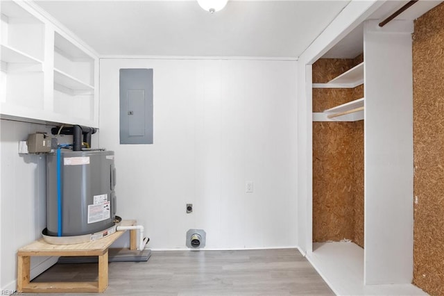 laundry room with electric dryer hookup, hardwood / wood-style floors, electric panel, and water heater