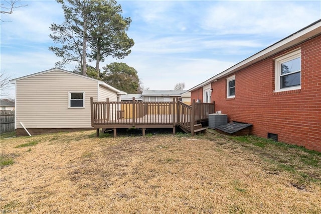 view of yard featuring a wooden deck and central AC unit