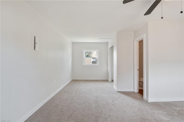 carpeted empty room featuring ceiling fan