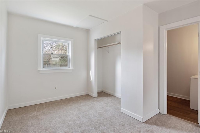 unfurnished bedroom with light carpet and a closet