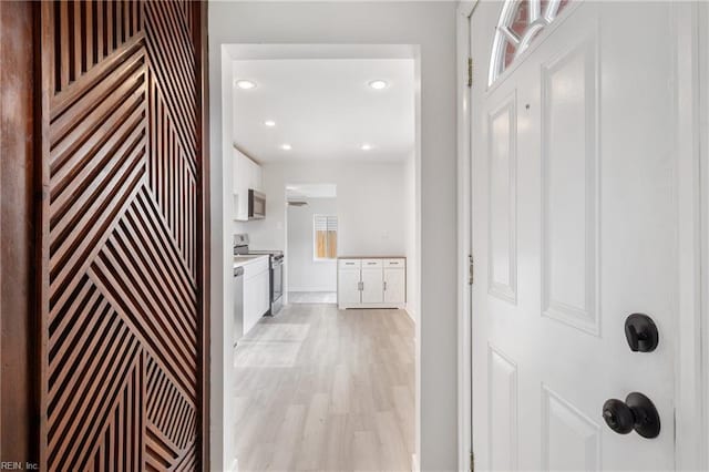 hallway with light hardwood / wood-style floors