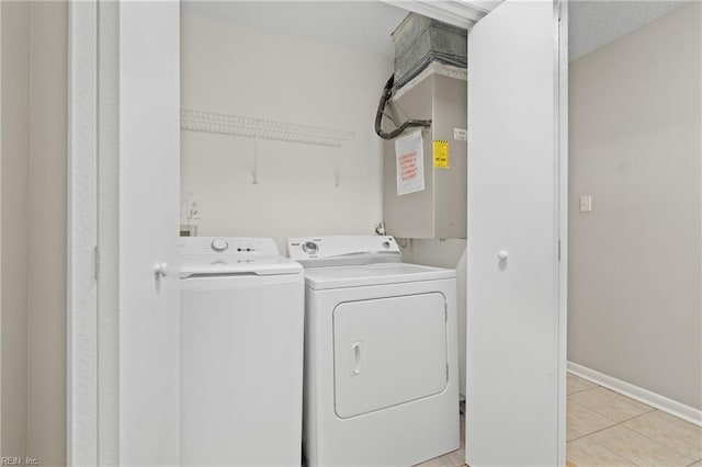 laundry room featuring light tile patterned flooring and separate washer and dryer