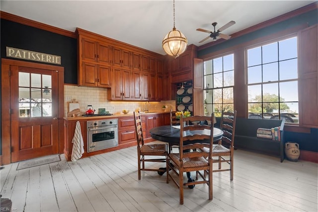 dining room featuring ceiling fan, plenty of natural light, and light hardwood / wood-style floors