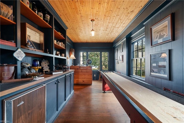 recreation room with dark hardwood / wood-style floors and wood ceiling