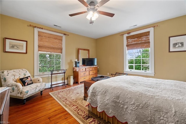 bedroom featuring wood-type flooring and ceiling fan