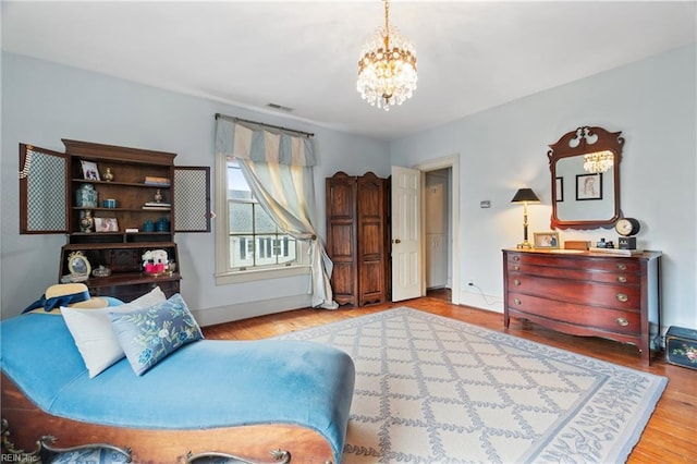 living area with an inviting chandelier and light hardwood / wood-style floors