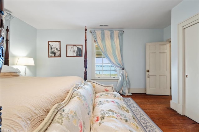 bedroom with hardwood / wood-style flooring and a closet