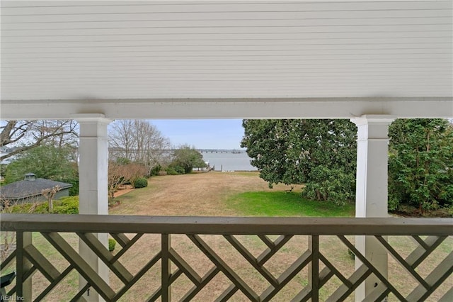 exterior space featuring a lawn and a water view