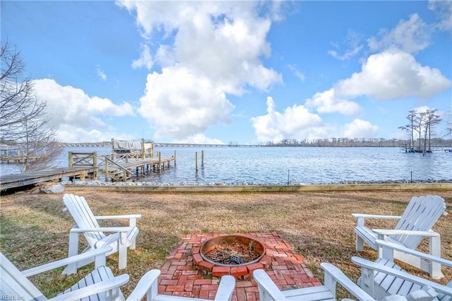 view of dock featuring a water view and a fire pit