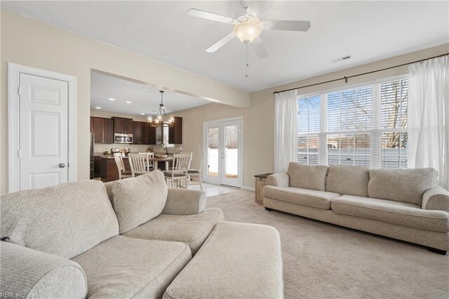 2608 River Watch Dr, Suffolk, VA 23434 - living room featuring beam ceiling, ceiling fan with notable chandelier, and light carpet
