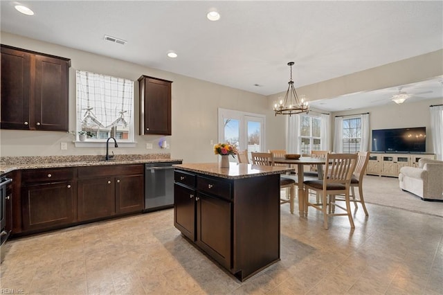 2608 River Watch Dr, Suffolk, VA 23434 - kitchen with stainless steel dishwasher, a center island, light stone countertops, and hanging light fixtures