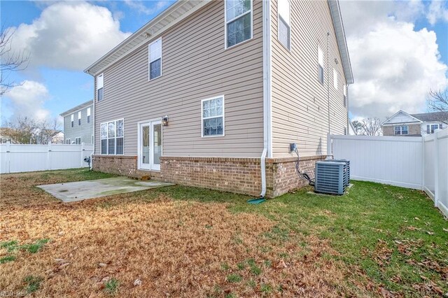 2608 River Watch Dr, Suffolk, VA 23434 - back of property featuring a lawn, a patio area, and central air condition unit