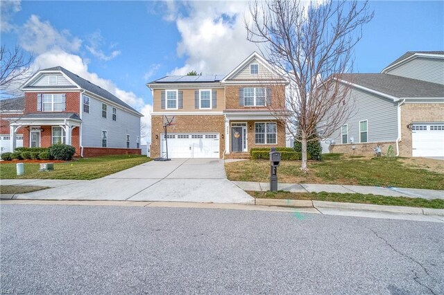 2608 River Watch Dr, Suffolk, VA 23434 - view of front of home with a garage, a front lawn, and solar panels