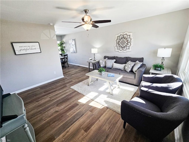 living room with dark wood-type flooring and ceiling fan