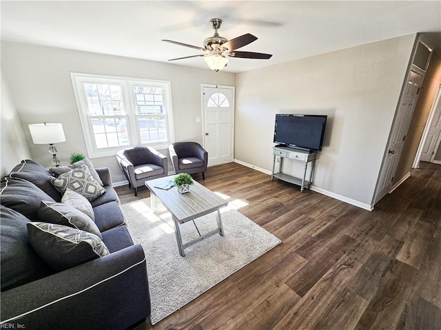 living room with dark hardwood / wood-style flooring and ceiling fan