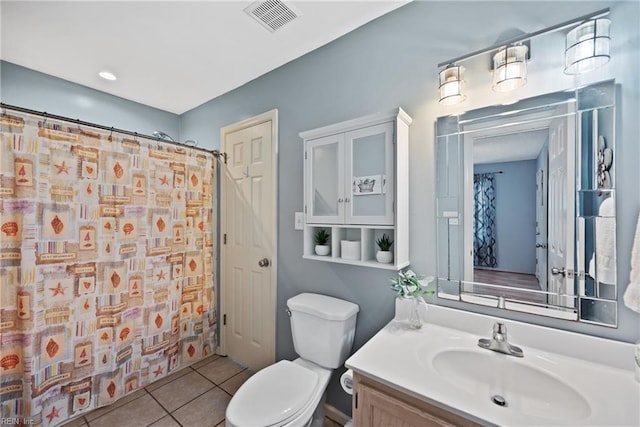 bathroom with a shower with curtain, vanity, toilet, and tile patterned flooring