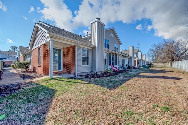 view of side of property with a lawn