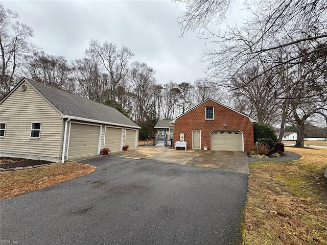 view of side of property featuring an outbuilding and a garage