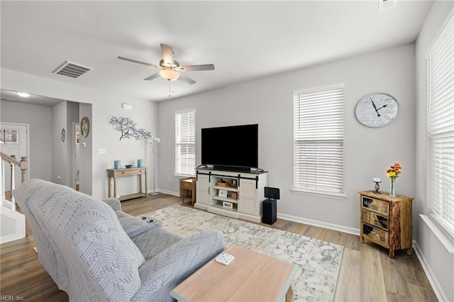 living room featuring hardwood / wood-style flooring and ceiling fan