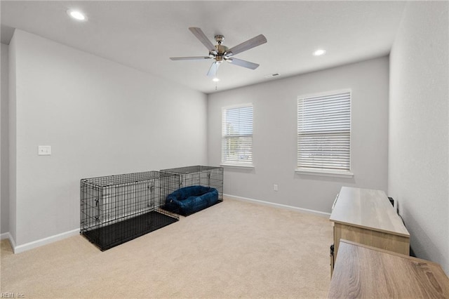 misc room with ceiling fan and light carpet