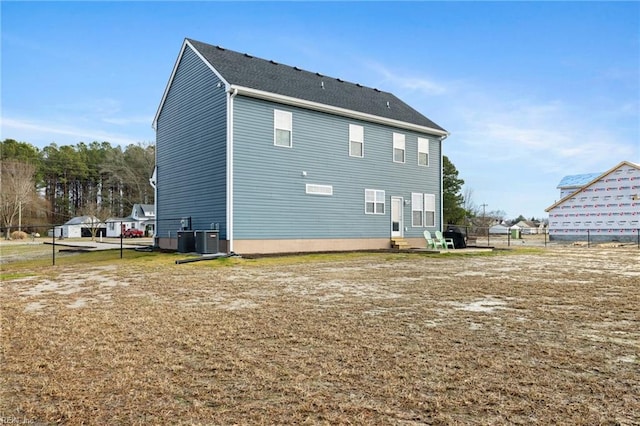 rear view of house featuring central AC unit