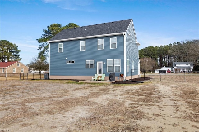 rear view of house with central AC and a patio area