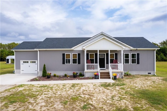 view of front of property featuring a garage, a front yard, and covered porch