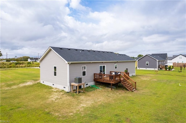 rear view of property with a wooden deck, a yard, and central AC unit