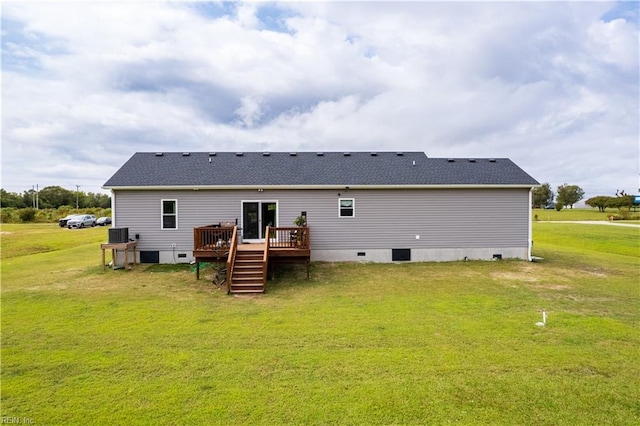 back of house featuring a wooden deck and a lawn