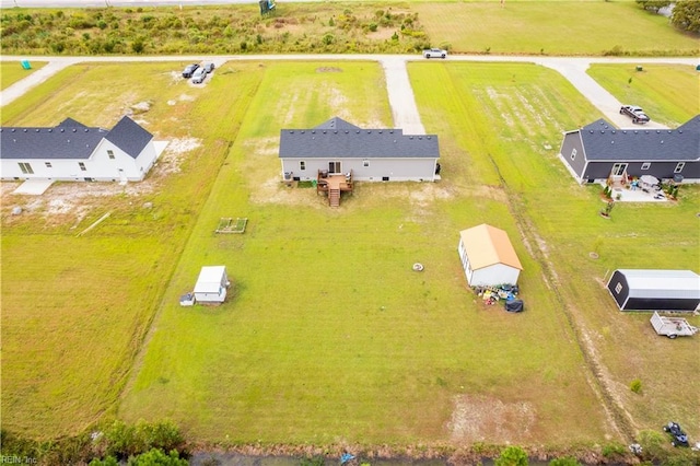 birds eye view of property with a rural view