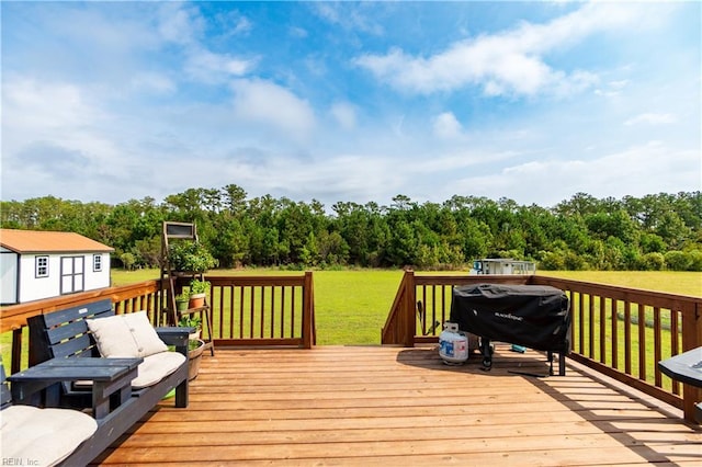 deck featuring grilling area and a yard