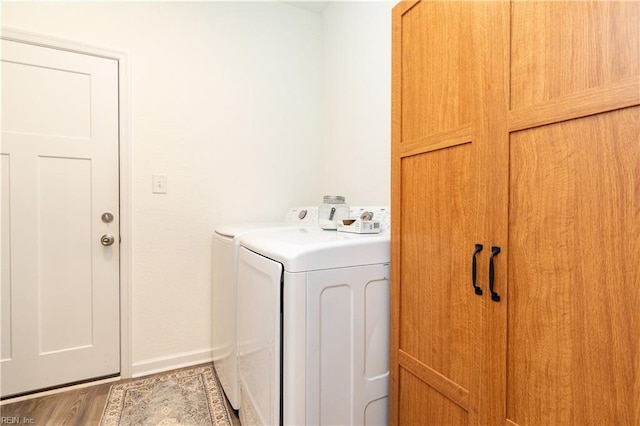 clothes washing area featuring independent washer and dryer and hardwood / wood-style floors