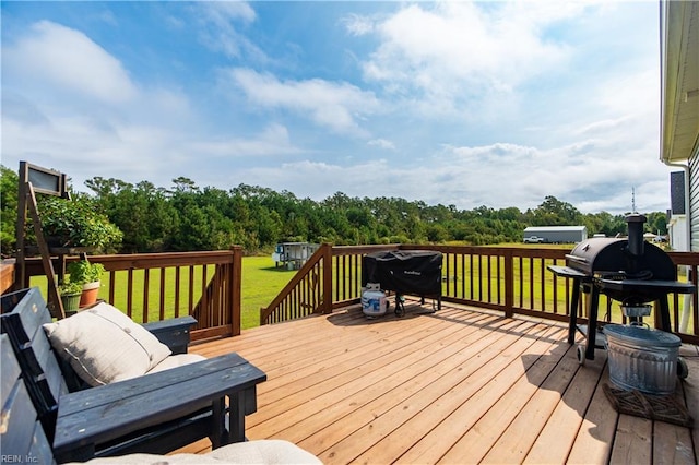 wooden terrace with grilling area and a lawn