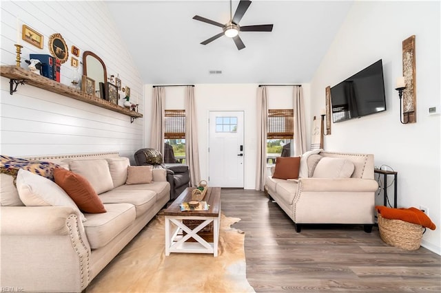 living room with wood-type flooring, ceiling fan, and high vaulted ceiling