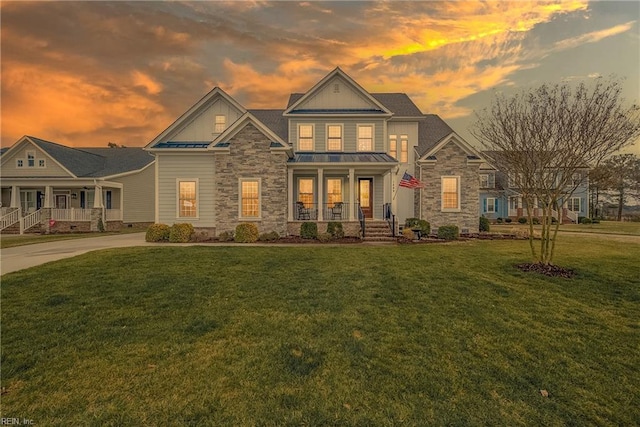 exterior space featuring covered porch and a lawn