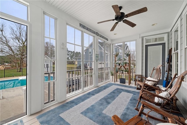 sunroom / solarium featuring ceiling fan and plenty of natural light