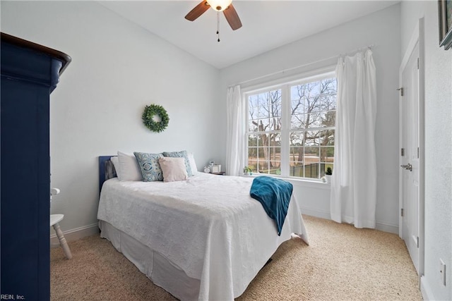 bedroom featuring ceiling fan, vaulted ceiling, and carpet